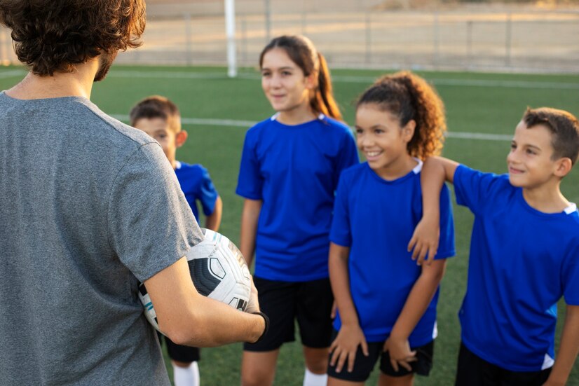 side-view-football-trainer-talking-kids_23-2149742049